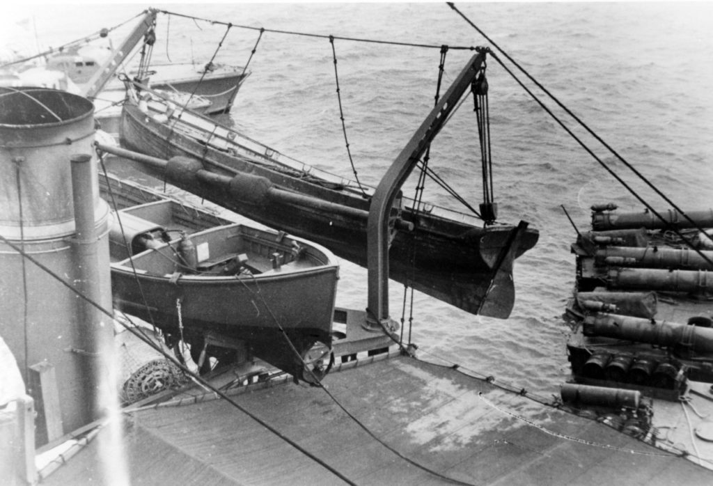 Cutter from the sunken Japanese aircraft carrier Hiryu, suspended from the starboard boat davits of USS Ballard (AVD-10)