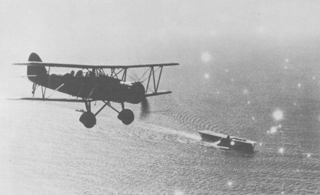 Japanese Navy Type 96 biplane fighter flying over Kaga, off China, 1937-1938