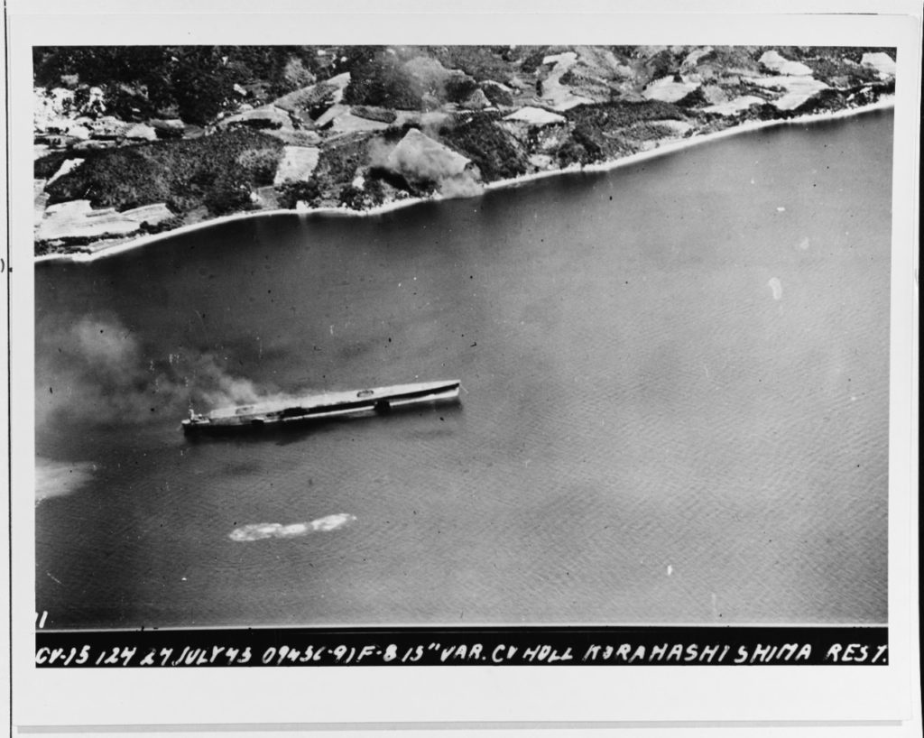 Partially completed Japanese aircraft carrier, either ASO or IKOMA, under air attack near Kure, 24 July 1945