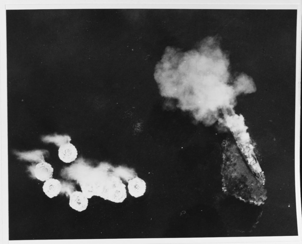 The incomplete Japanese aircraft carrier Ikoma on fire during attacks by U.S. Navy carrier planes, at Kobe, 19 March 1945