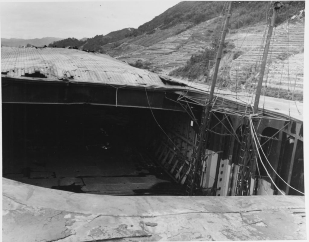 Damage to the flight deck of Ryuho at Kure, Japan, 9 October 1945 Taken by the after elevator, looking forward