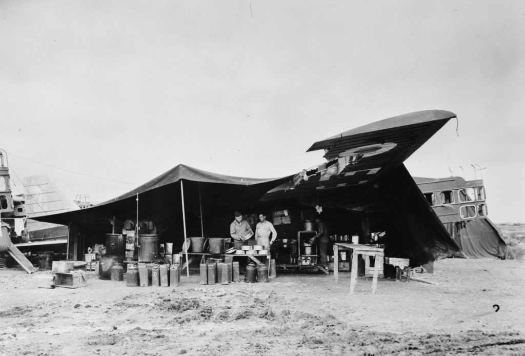 A U.S. field kitchen constructed under the wing of an derelict French Bloch MB.200 bomber in North Africa, 1943