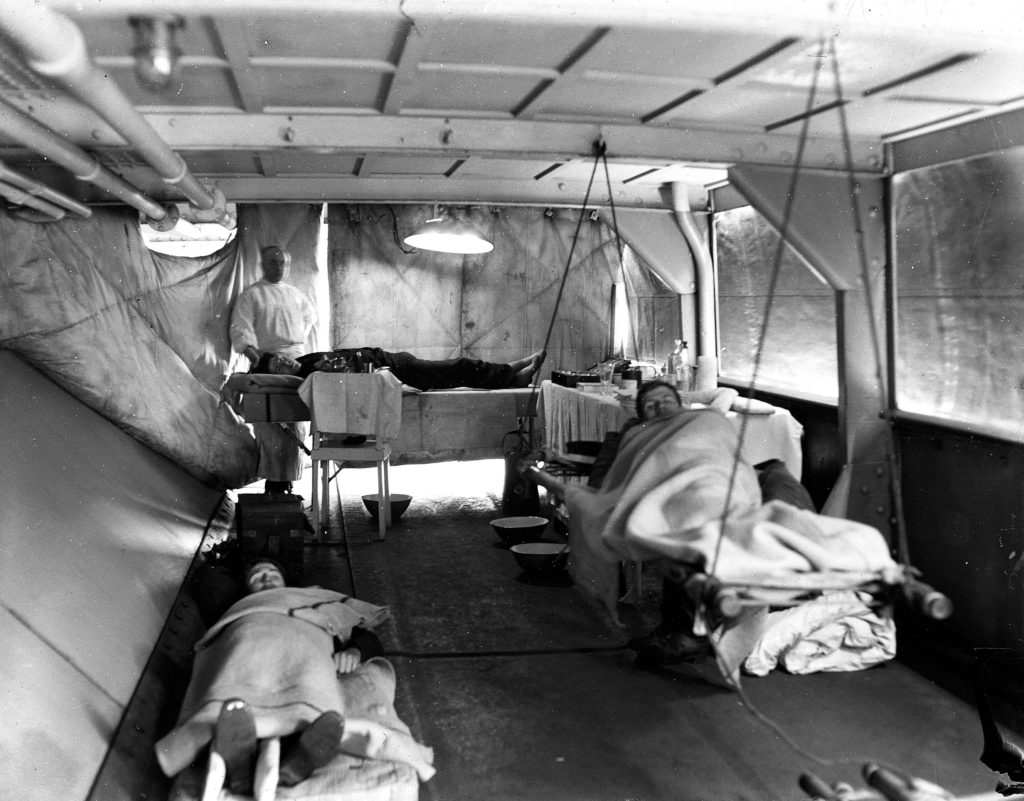 Credit: Wellcome Library, London. Wellcome Images images@wellcome.ac.uk http://wellcomeimages.org Photo showing wounded patients lying on stretchers at a World War I dressing station on board HMS Erebus, Monitor, Russia, c. 1919. Photograph 1900's Montague Henry Knapp Published: - Copyrighted work available under Creative Commons Attribution only licence CC BY 4.0 http://creativecommons.org/licenses/by/4.0/