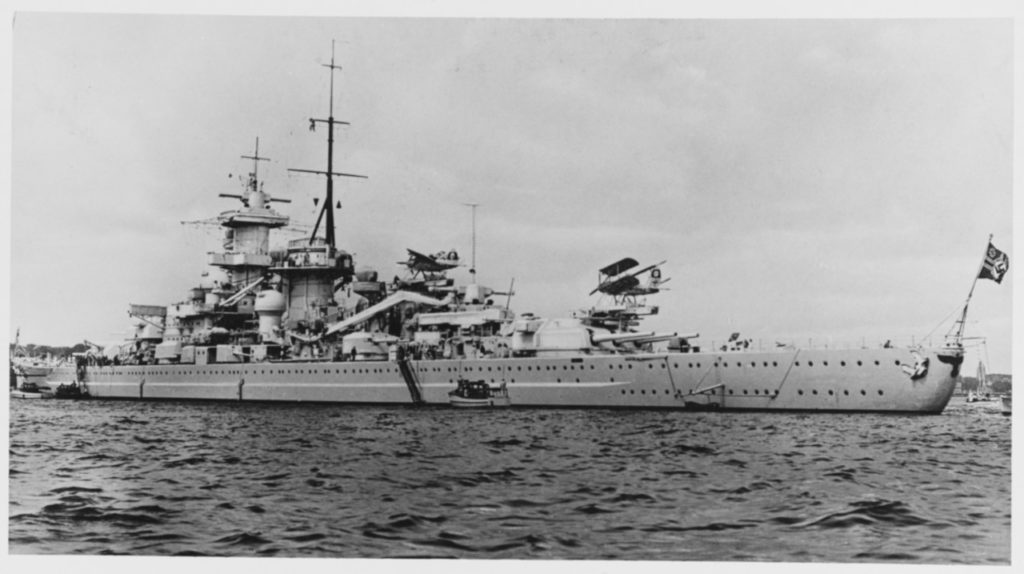 View of port side from astern, 1938. Note seaplanes on catapults a Heinkel HE 114 on the forward catapult and an Arado AR 95 on the catapult atop #3 turret