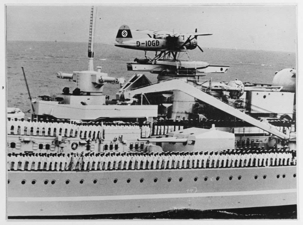 View taken 22 August 1938, during a fleet review, showing crewmen manning the rails. Note Heinkel HE. 114 seaplane on catapult.