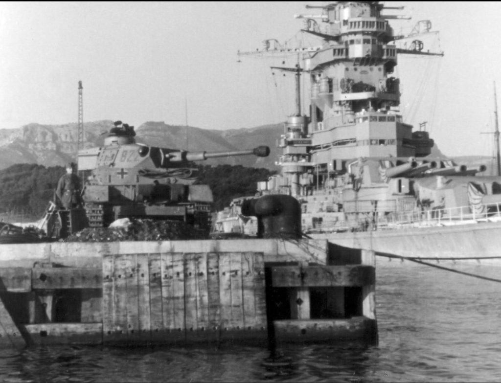 German Panzer IV (Ausf. G variant) looks on next to the scuttled Strasbourg