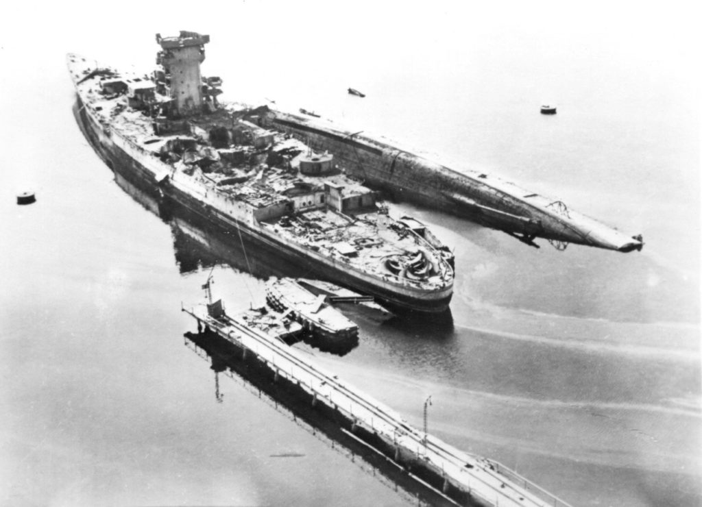 Strasbourg after having been bombed by US Army Air Force bombers on August 18, 1944. The capsized cruiser is the La Galissonnière