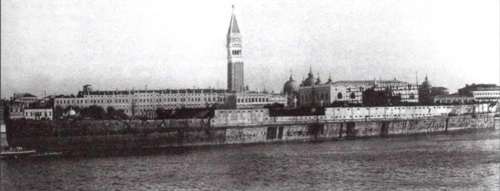 The raised hull of Impero in the Bacino San Marco at Venice, being towed to be scrapped, 1949