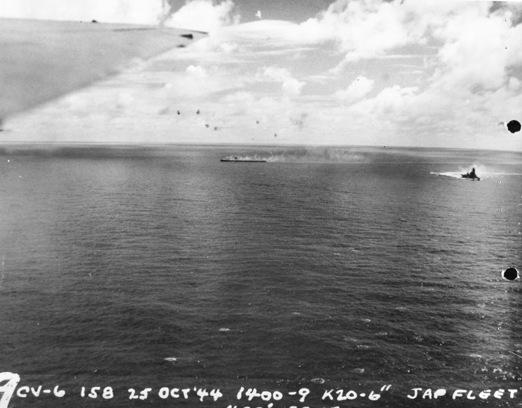 Zuikaku dead in the water listing and afire at about 1400 hrs 25 October, following the days third attack on the Japanese force Ship at right is the battleship Ise