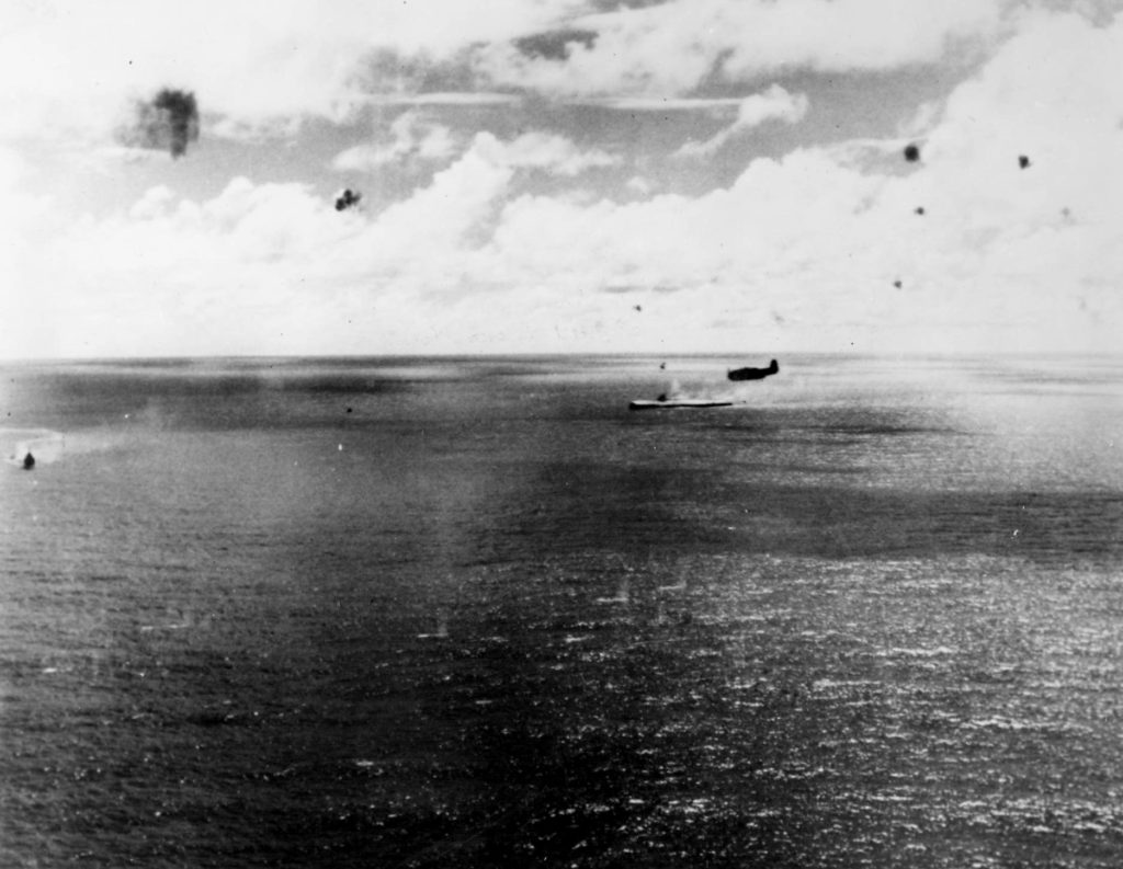 Zuikaku settling as she sinks 25 Oct 1944 profile of an Avenger is seen flying overhead