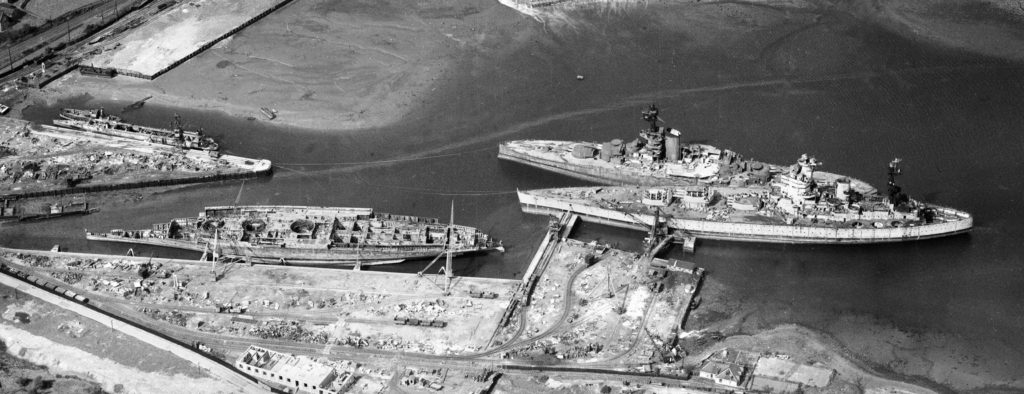 Hulks of the former HMS Revenge, HMS Rodney, and HMS Nelson being scrapped