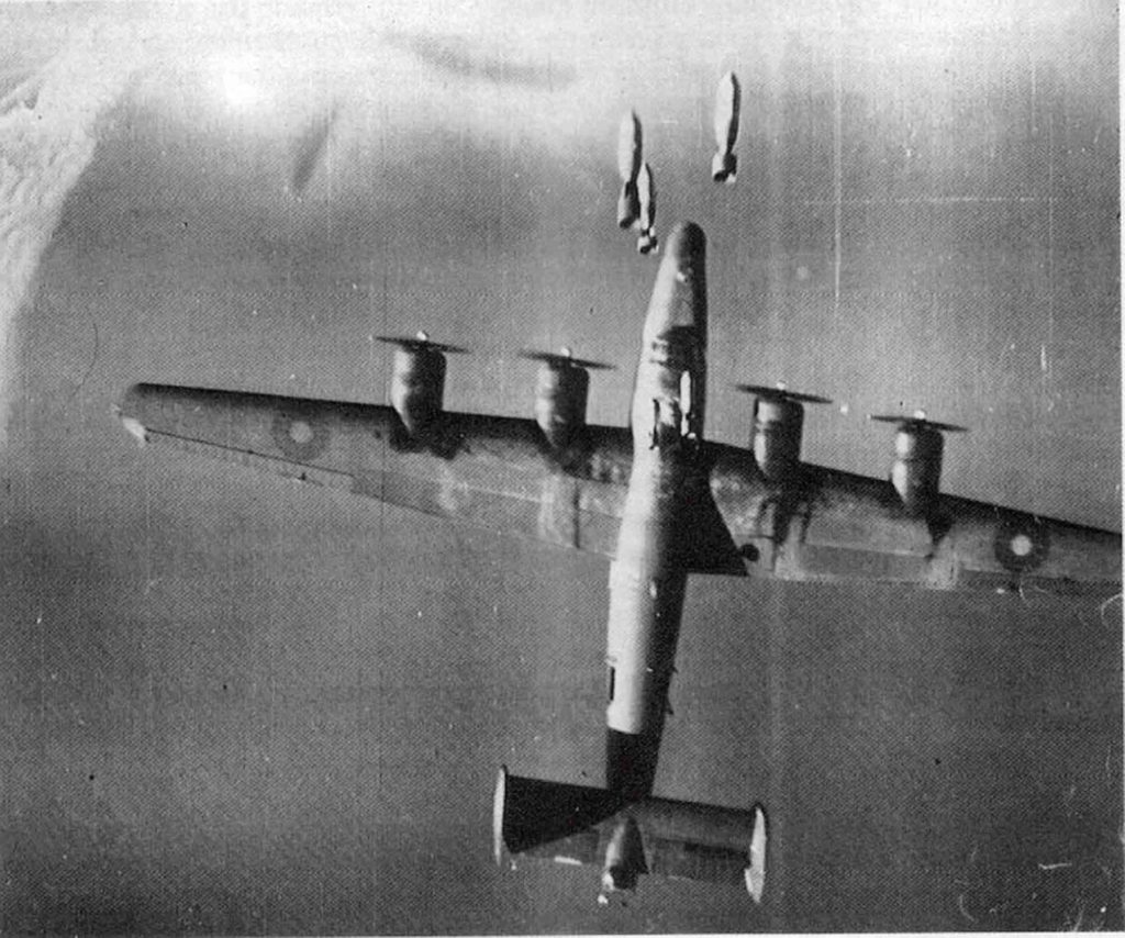 RAF Consolidated B-24 Liberator flying under another bomber that has just released its bombs