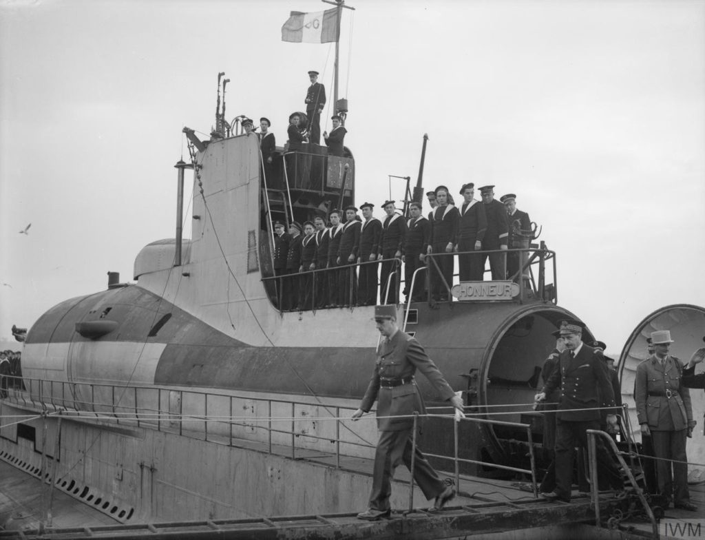 General de Gaulle leaving the submarine Surcouf after exiting from the open hangar door.