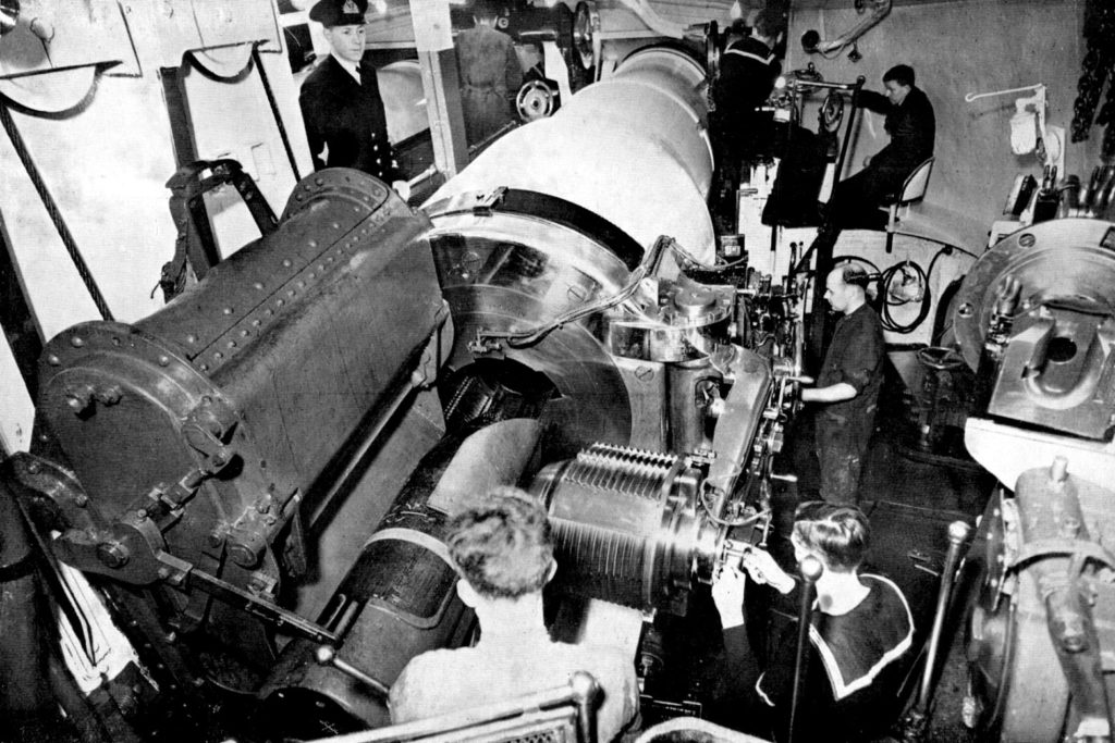 A gun crew on board HMS Iron Duke preparing to load a 13.5 inch shell into the breech of the gun, 1930s