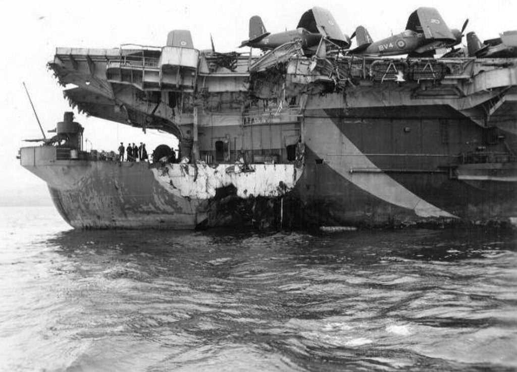 HMS Thane D48 after being torpedoed. The Port After gun sponson has been sheared off by the explosion and an enormous hole can be seen on the waterline