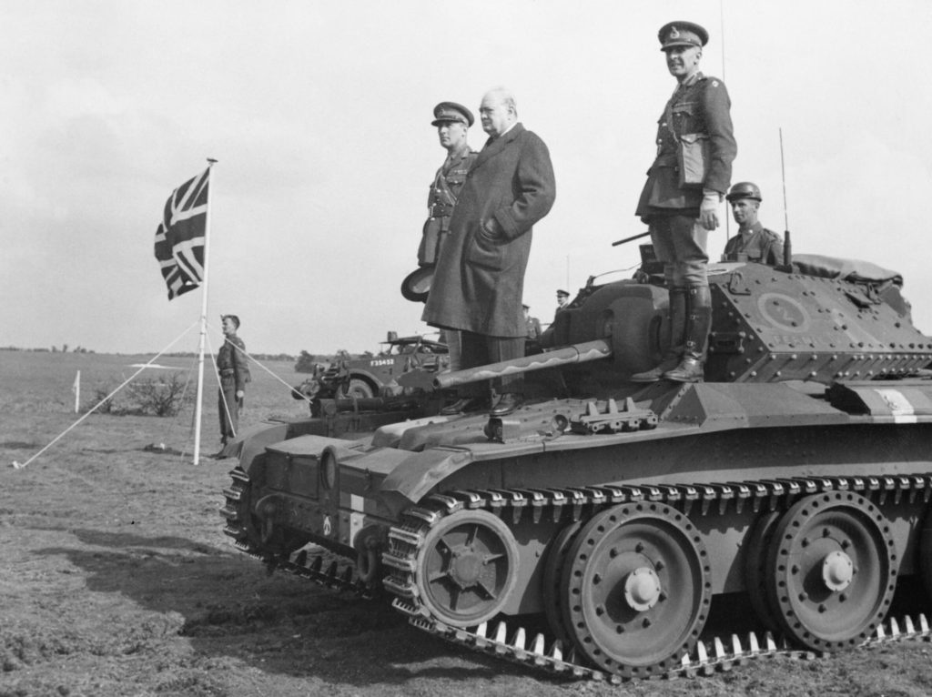 Winston Churchill stands on a Covenanter tank of 4th-7th Royal Dragoon Guards, to take the salute 16 May 1942