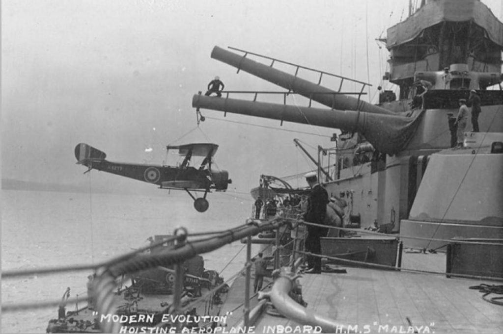 HMS Malaya using her 15 inch guns and turret as a crane to a Sopwith Pup