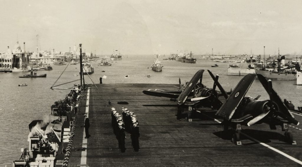 HMS Arbiter in Suez Canal with Vought Corsair fighters on deck