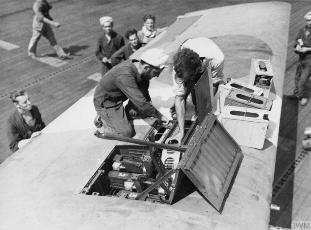 An 808 NAS Grumman Hellcat being re-armed aboard HMS Khedive April 1945