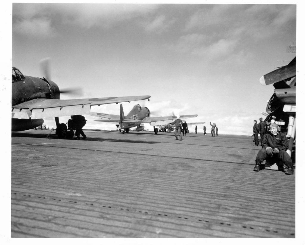 Hellcats waiting to take off from HMS Emperor.