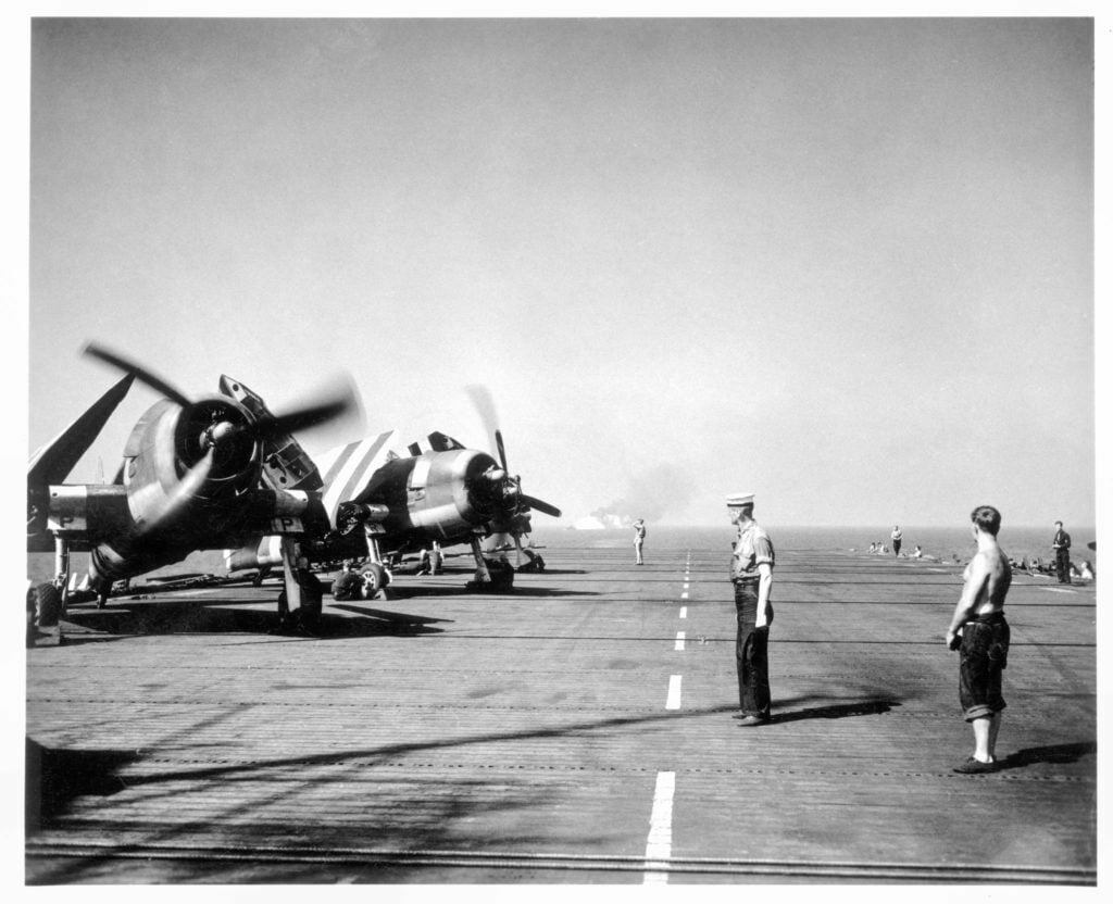 Hellcats waiting to take off from HMS Emperor.