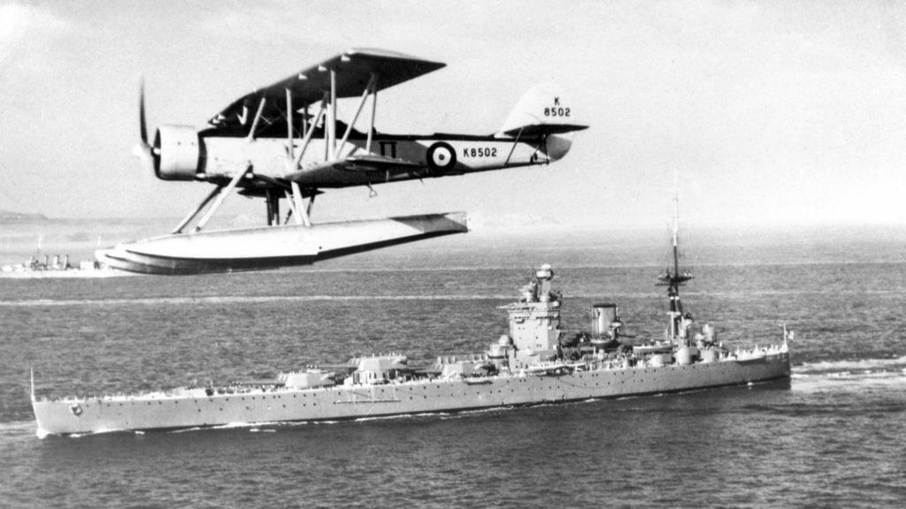 Blackburn Shark II K8502 flying past HMS Rodney in July 1938.