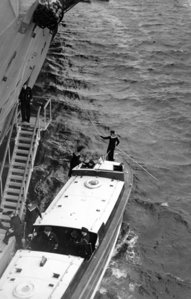 H.M. King George VI seen arriving on HMS Indomitable.