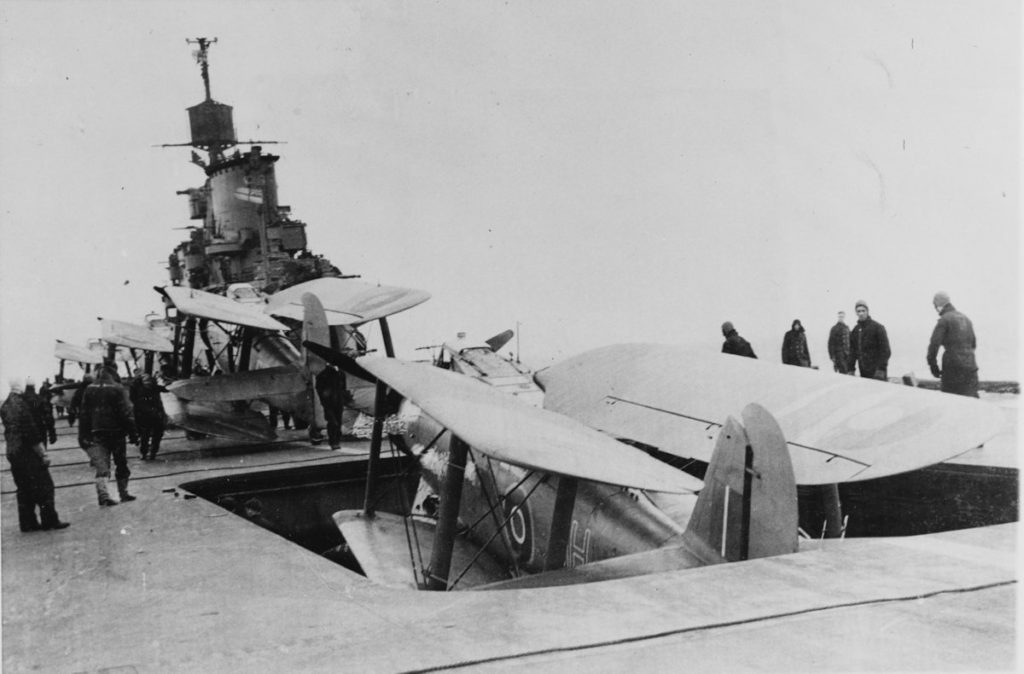 HMS Indomitable Striking Fairey Albacore aircraft below, during 1940.