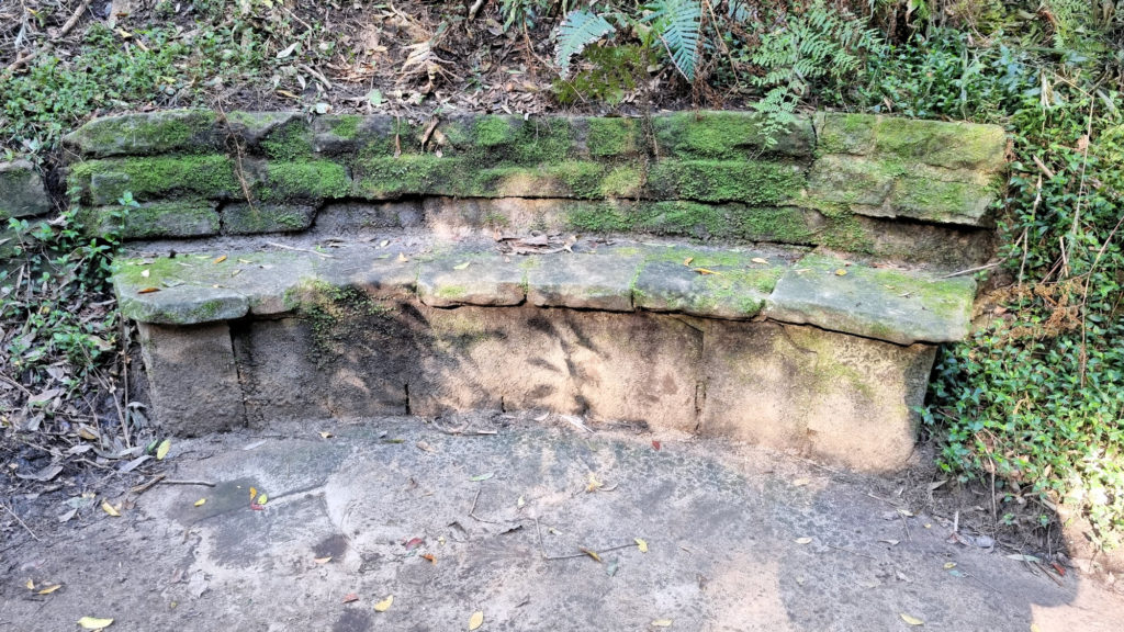 Moss covered stone bench seat Cooper Park