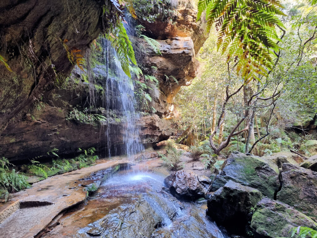 A Small Waterfall Over the Track. Hikers have to go Behind it.