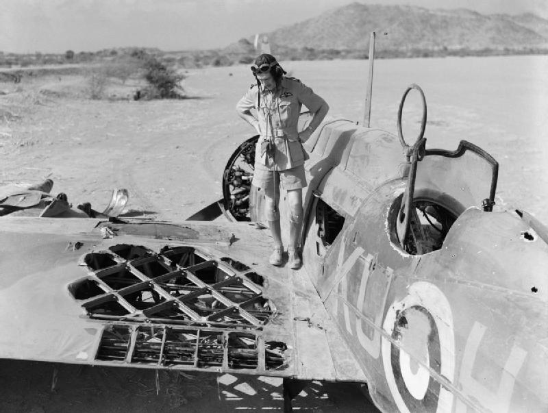 Pilot Officer Kennedy 47 Squadron inspects the damage to his Wellesley, K7715 KU-H at Agordat Eritrea caused by 2 Fiat CR.42 fighters