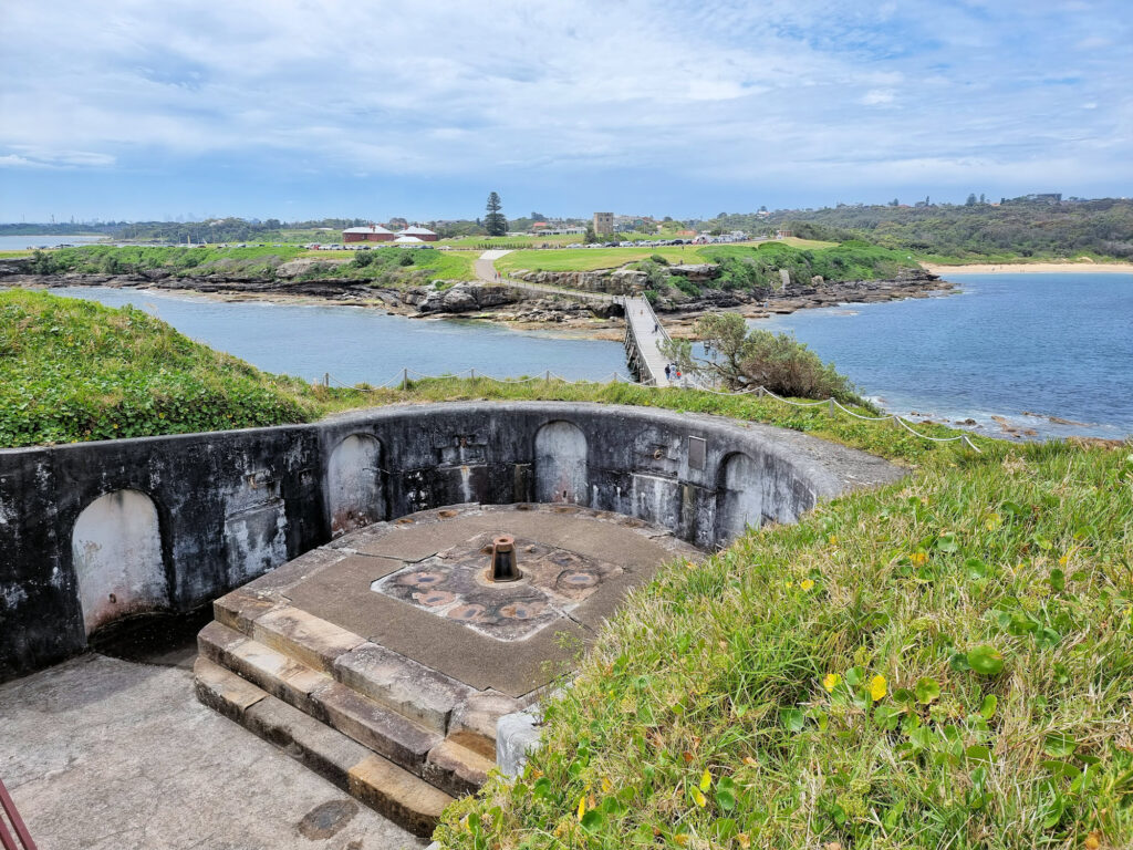 Gun pit with a view of the connecting bridge to Bare Island