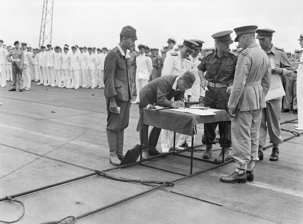 Surrender of Japanese forces in Bismarck Archipelago and New Guinea being formally accepted on board HMS Glory by the Australian General Sturdee at Rabaul.