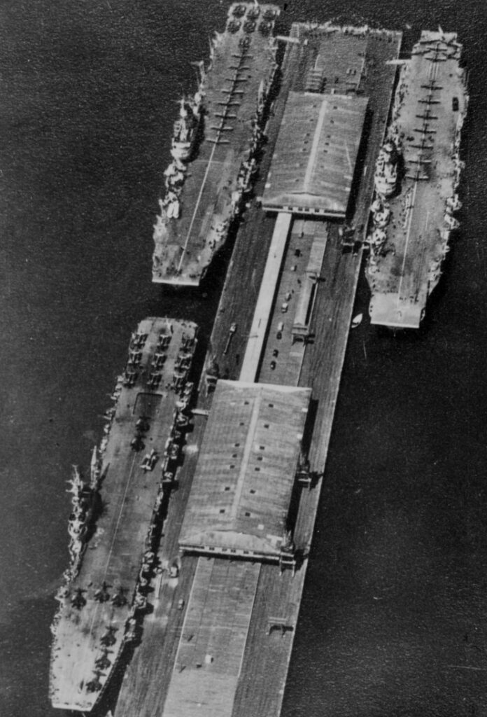 HMS Glory (bottom, HMS Implacable (top left) and HMS Indefatigable tied up at Sydney, Australia