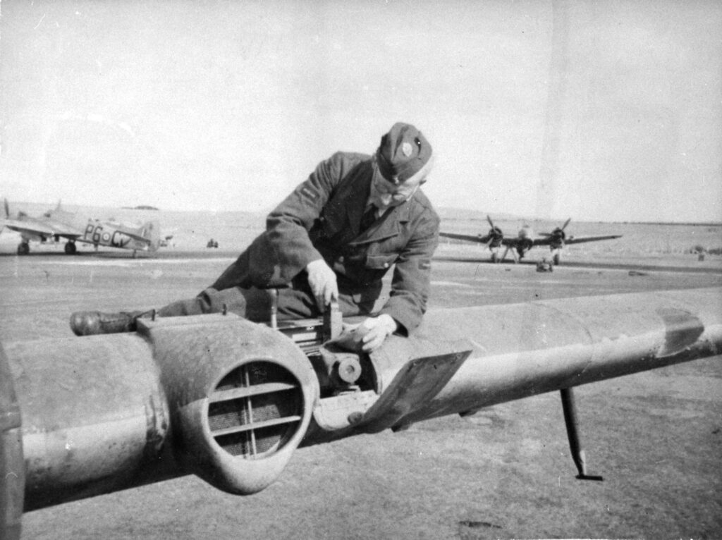 Loading a film cassette into the gun camera of a No. 489 Sqn Bristol Beaufighter