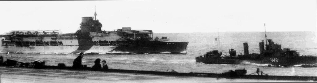 HMS Glorious painted in camouflage with the destroyer HMS Diana