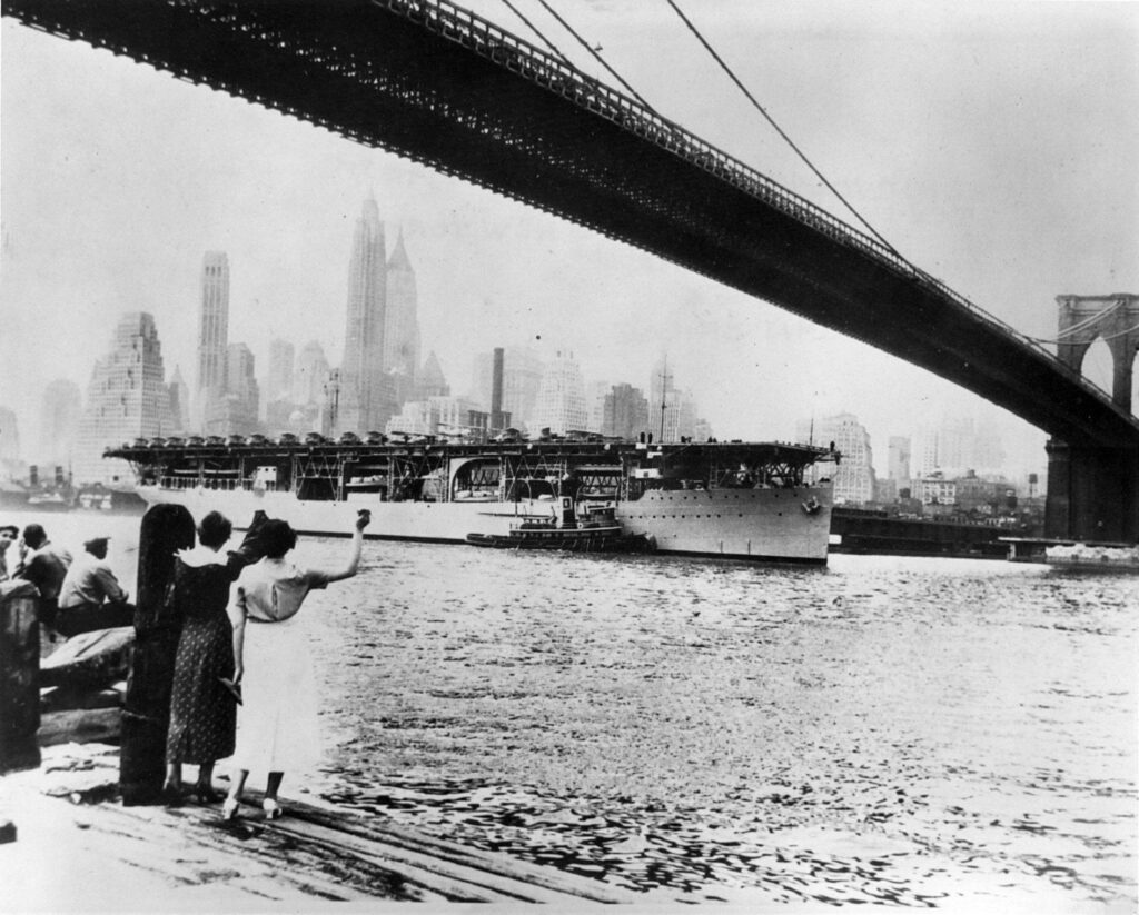 USS Langley CV-1 under the Brooklyn Bridge in New York City 1934