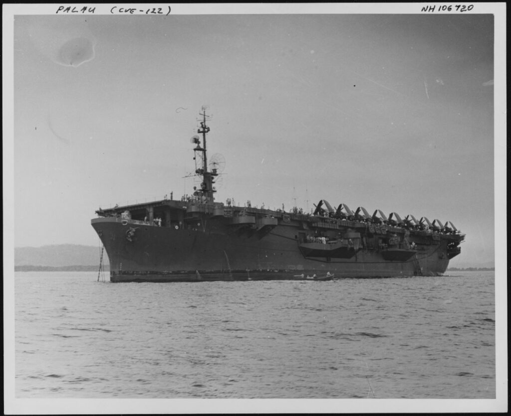 USS Palau CVE-122 at anchor, with F4U Corsair fighters parked on her flight deck. July 1947