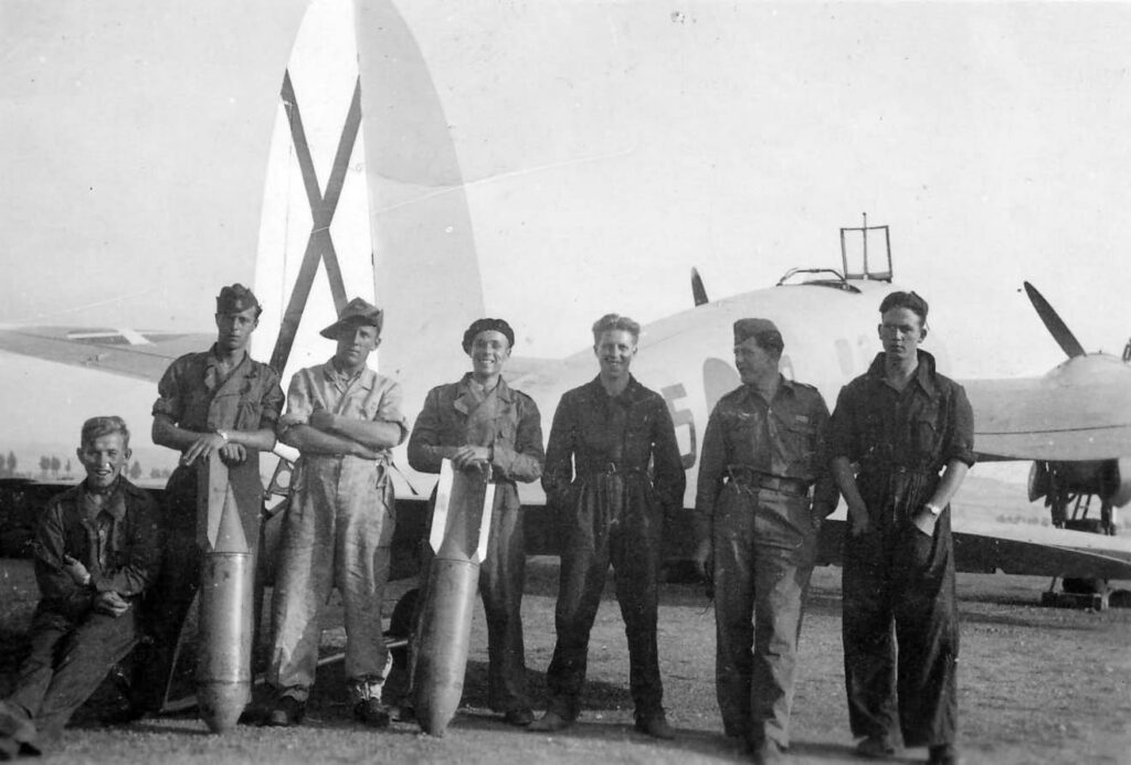 Ground crew of Legion Condor poses with aerial bombs. Heinkel He 111 B in the background