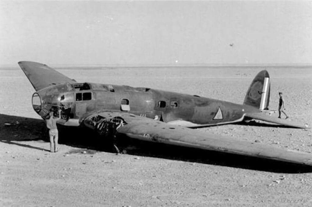 Wrecked Iraqi Heinkel He 111 being inspected by a British serviceman