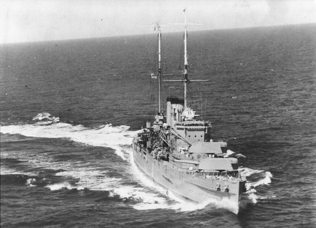 HMS Exeter training her 8 inch guns to starboard