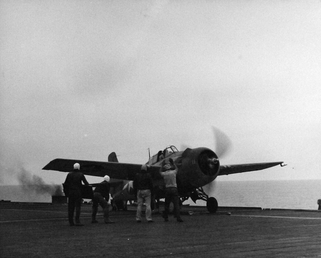 An FM-2 Wildcat fighter preparing for launch aboard USS Matanikau (CVE-101) 27 July 1944