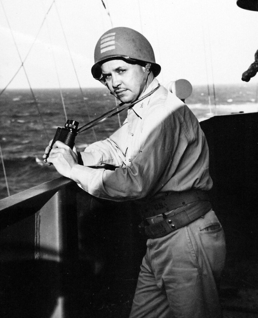 Captain Hugh H. Goodwin, USN, Commanding Officer of USS Gambier Bay (CVE-73) on the navigation bridge, 20 February 1944