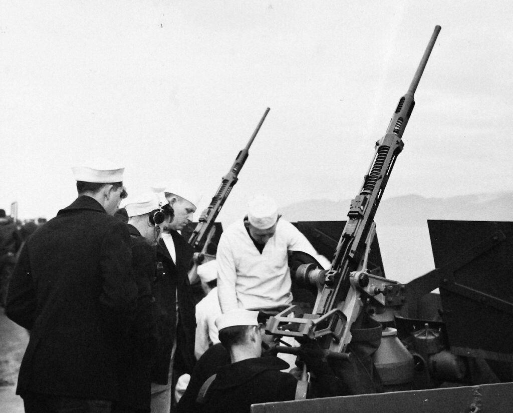 Gun crew receiving instructions in anti-aircraft gun-firing aboard USS Gambier Bay (CVE-73), 14 January 1944