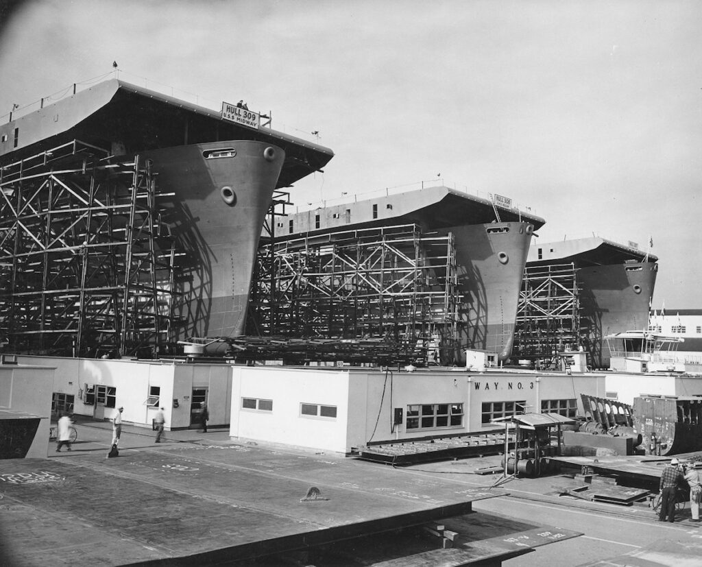 Left to right the future USS Midway; slated to be HMS Begum but completed as USS Natoma Bay; future USS Manila Bay April–August 1943