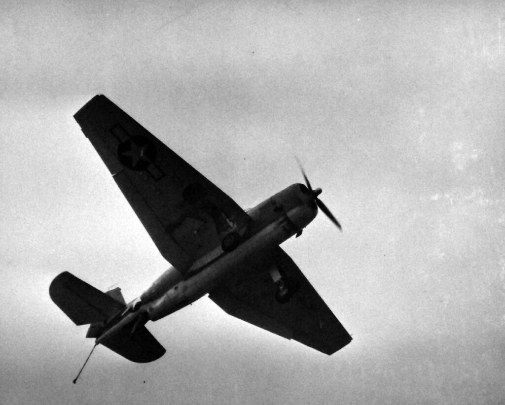 A TBM Avenger recovering aboard USS Matanikau (CVE-101), 16 October 1944