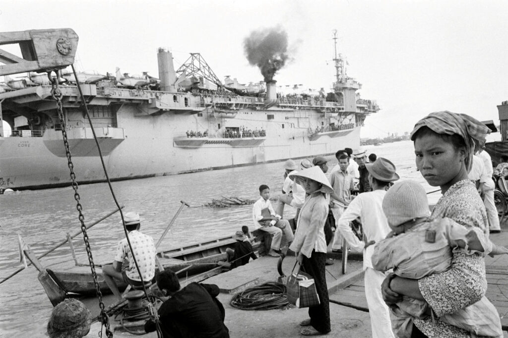 USNS Core (T-AKV 41) docks at Saigon harbor, South Vietnam