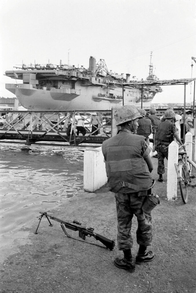 USNS Core (T-AKV 41) docks at Saigon harbor, South Vietnam