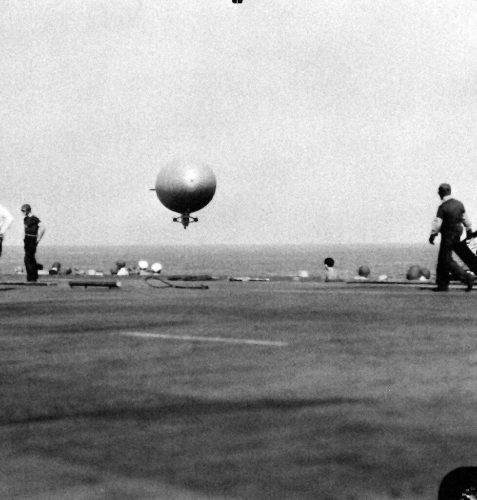 USS Matanikau (CVE-101), with K-blimp coming in to be secured, 14 October 1944