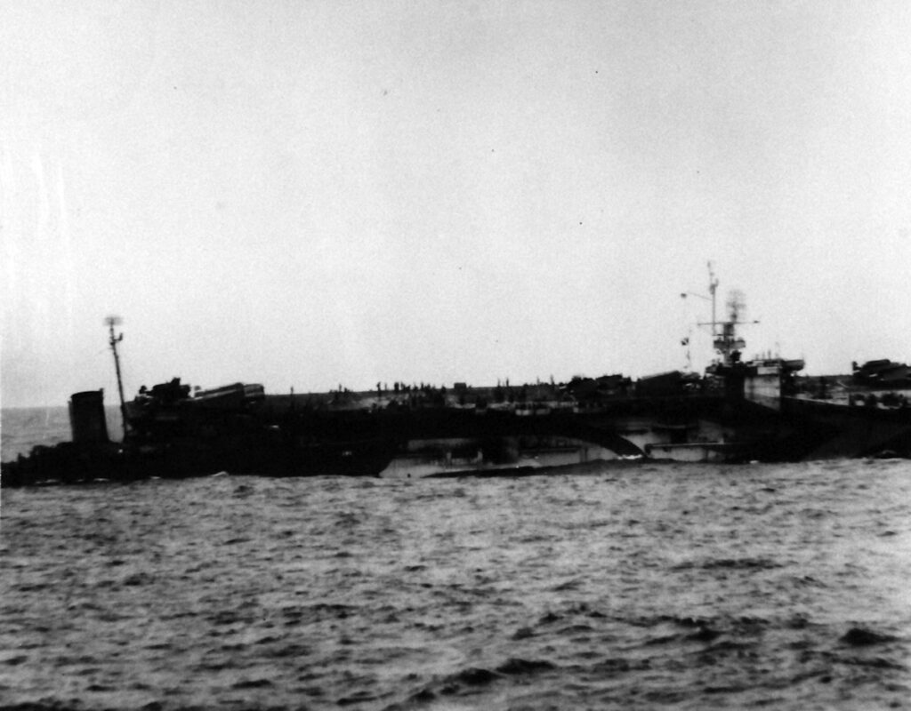 USS Salamaua (CVE-96) shown five minutes after being hit by a Japanese suicide plane 13 January 1945